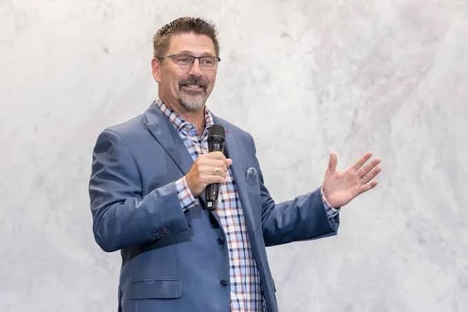 Rick Torrison speaking on stage